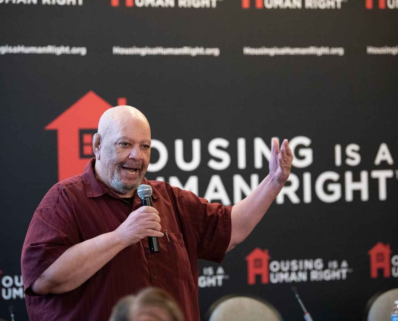 An advocate speaking at a Housing is a Human Right event